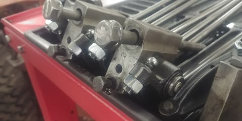 1996 Ford Bronco - Close-up view of engine valve train parts, including pushrods and rocker arms.