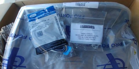 1996 Ford Bronco - Packaging for Ford Bronco parts, including headlamp retaining clips, is shown.
