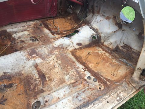 1962 Ford Galaxie - The interior floor pan of a 1962 Ford Galaxie shows significant rust and deterioration.