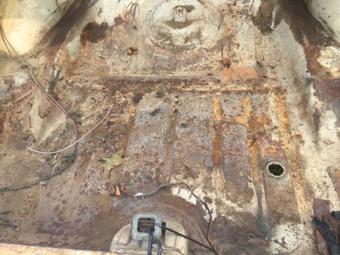 1962 Ford Galaxie - This photo shows a heavily rusted car floor pan, not a 1962 Ford Galaxie.