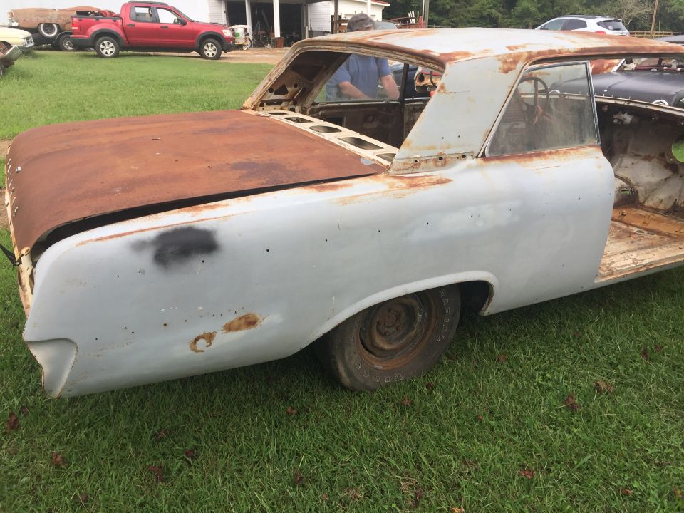 Rusty 1962 Ford Galaxie coupe in primer, rear quarter view