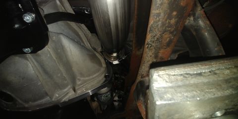 1996 Ford Bronco - Underside view of a vehicle's exhaust pipe and transmission housing, with visible text from Supermotors.net.