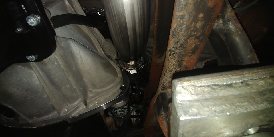 Exhaust pipe and transmission housing under a vehicle