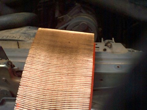 1988 Ford Bronco - A dirty engine air filter is shown in the engine bay of a vehicle.