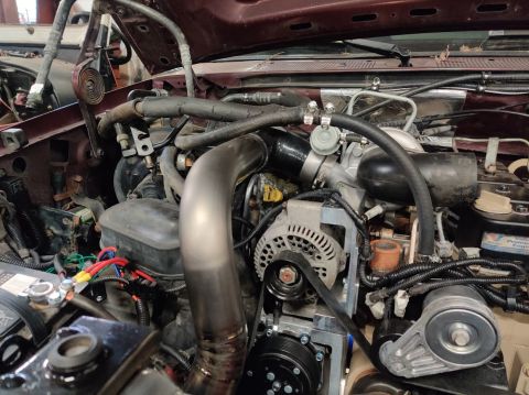 1996 Ford Bronco - Close-up view of a vehicle's engine bay, showing various components and custom modifications.