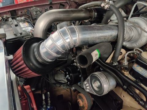 1996 Ford Bronco - Custom turbocharger and intake system installed in an engine bay, a Holset turbocharger.