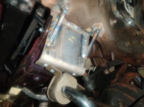 1996 Ford Bronco - Close-up view of a custom-fabricated bracket attached to the vehicle's frame, likely for modification or repair.