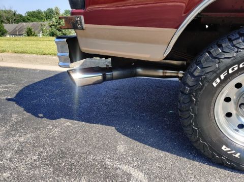 1996 Ford Bronco - Close-up of the exhaust pipe and tire on a 1996 Ford Bronco.