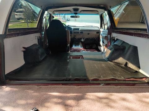 1996 Ford Bronco - The interior of a 1996 Ford Bronco, with the rear cargo area stripped down and the dashboard visible.