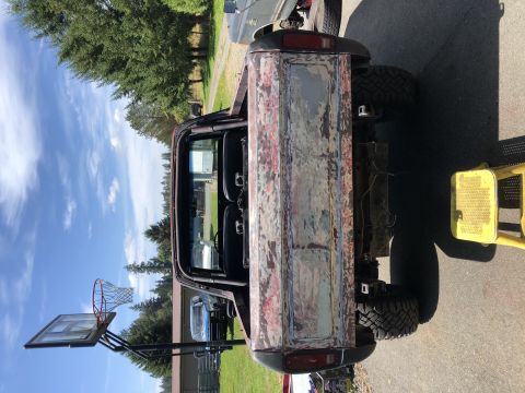 1978 Ford Bronco - This Ford Bronco's tailgate is prepped for paint, showing primer and rust patches.