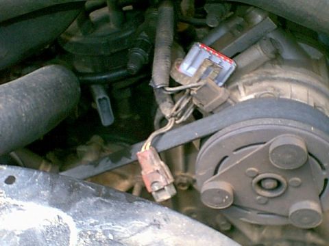 1988 Ford Bronco - This image shows a close-up view of a vehicle's engine compartment, focusing on the belt and pulley assembly.