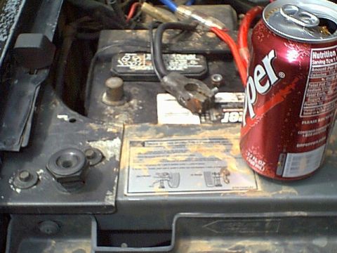 1988 Ford Bronco - A car battery is shown with a Dr Pepper can. The battery terminals and wires are visible.