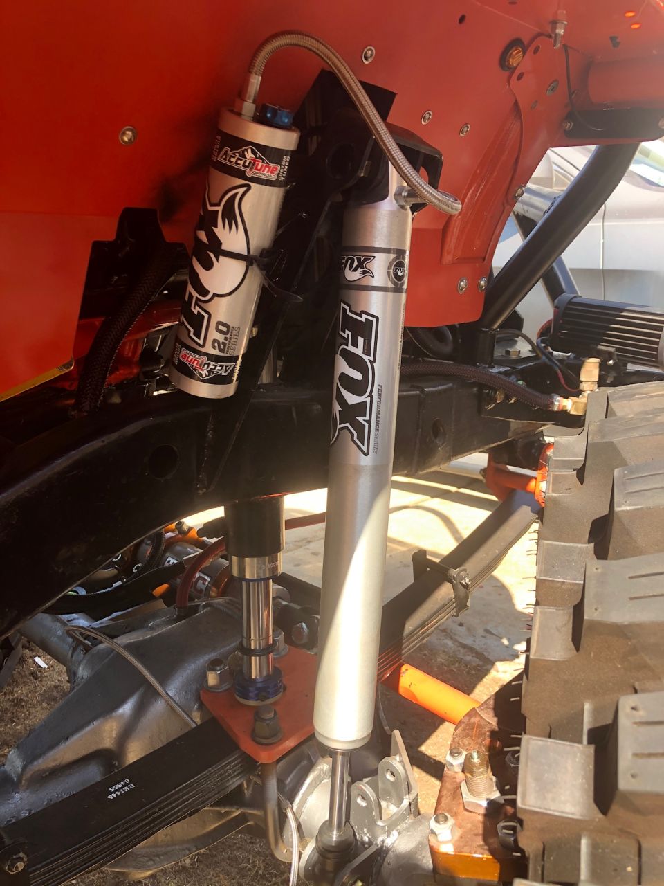 Close-up of Fox Performance Series shocks on an off-road vehicle suspension.