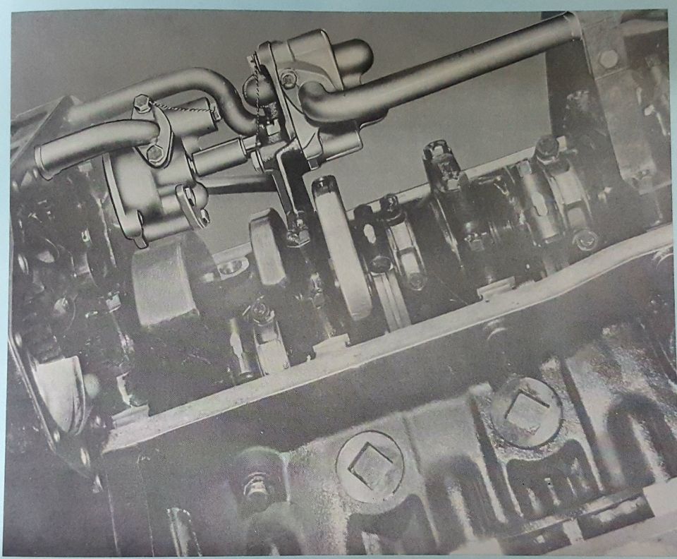 Close-up of internal engine components including crankshaft, connecting rods, and oil pump.