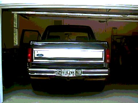 1986 Ford F-150 - The rear of a pickup truck is visible parked inside a garage. Year identification is not possible from this image.