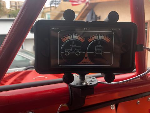 1992 Jeep Wrangler - A smartphone mounted inside a red Jeep Wrangler displays an inclinometer app showing pitching and rolling angles. The mount is attached to…