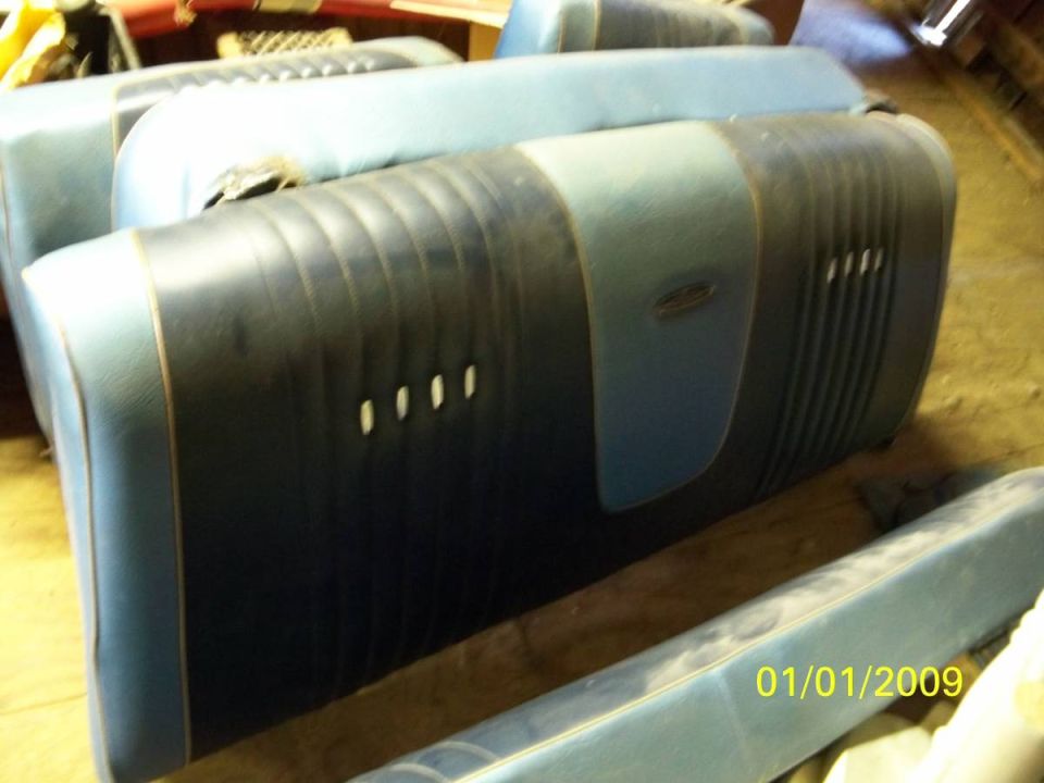 Two upholstered car seats, one stacked on top of the other, with blue and dark blue fabric.