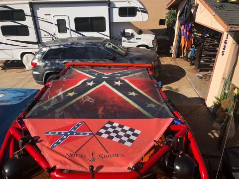1992 Jeep Wrangler - A custom dune buggy with a red frame is parked in a driveway next to an RV and a dark gray SUV. The buggy's canopy features a large Confede…