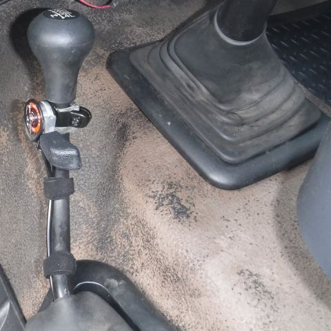 1992 Ford Bronco - Hand throttle lever mounted to the transfer case shifter. Rather than an adapter, I used a couple wraps of bicycle tire tube to snug it up…