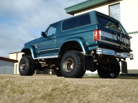 1996 Ford Bronco - This 1996 Ford Bronco is shown in a teal color with a lifted suspension and large off-road tires.