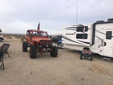 1992 Jeep Wrangler - Modified 1992 Jeep Wrangler parked beside a Sunseeker RV in a desert setting.
