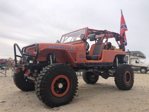 1992 Jeep Wrangler - Modified orange Jeep Wrangler with "GENERAL LEE" and "01" graphics, equipped for off-roading.