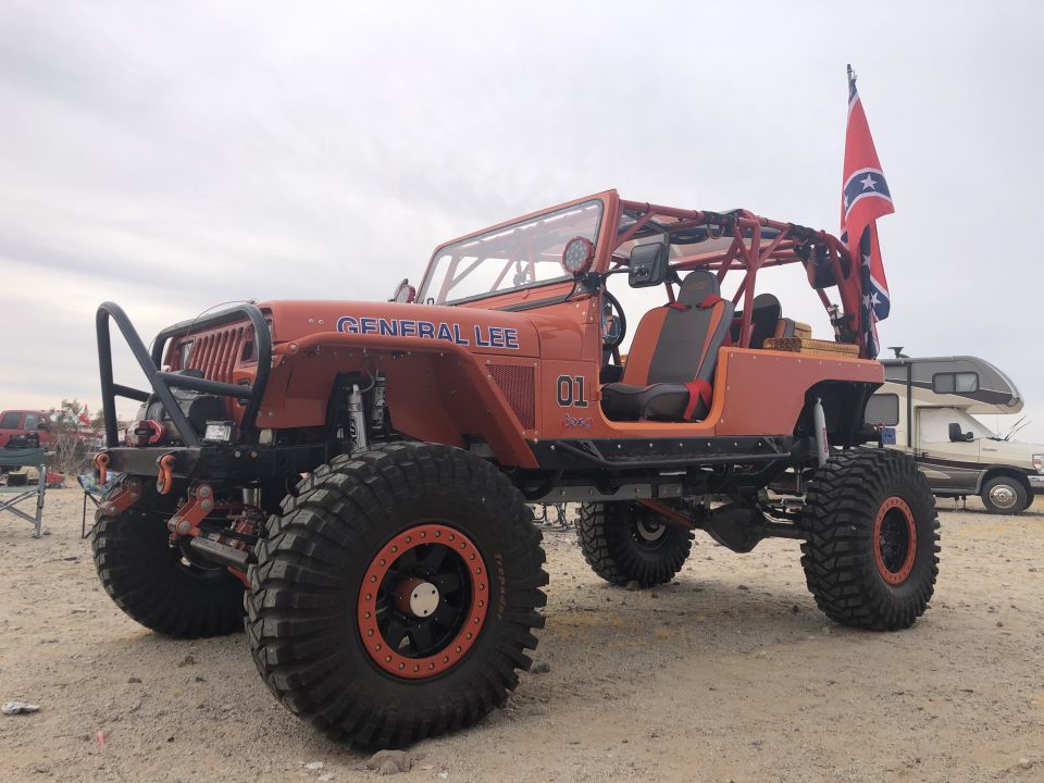 Orange Jeep Wrangler with "GENERAL LEE" text, "01" graphic, and Confederate flag