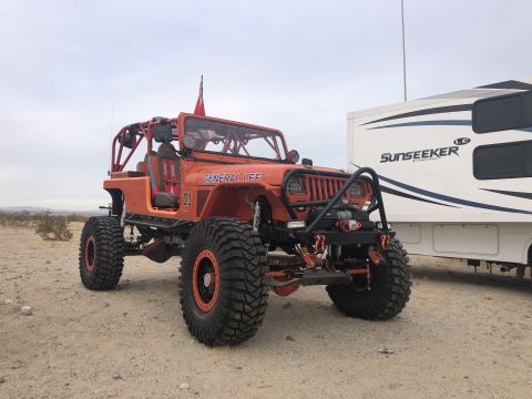 1992 Jeep Wrangler - This modified 1992 Jeep Wrangler features a full roll cage and oversized tires, ready for off-road adventures.