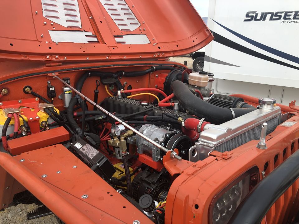 1992 Jeep Wrangler engine bay with orange paint and aftermarket parts