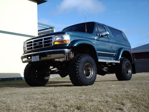 1996 Ford Bronco - This lifted 1996 Ford Bronco features large off-road tires and a prominent grille.