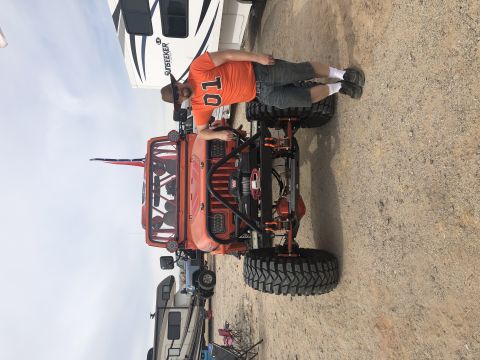 1992 Jeep Wrangler - Man poses with his modified orange Jeep Wrangler, likely from the early 1990s.