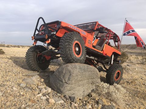 1992 Jeep Wrangler - Modified Jeep Wrangler with "GENERAL LEE" and "01" markings navigates rocky terrain, flying a Confederate flag.