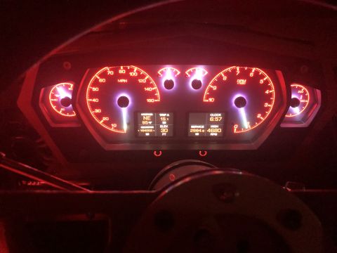 1992 Jeep Wrangler - The illuminated dashboard displays a clock at 6:57 and other vehicle information.