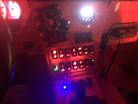1992 Jeep Wrangler - The interior of a vehicle features a custom dashboard with numerous illuminated switches and gauges.