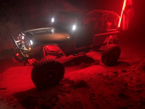 1992 Jeep Wrangler - Modified 1992 Jeep Wrangler with off-road lights and underglow in a desert setting.