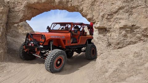 1992 Jeep Wrangler - This modified Jeep navigates a narrow passage in a desert landscape.