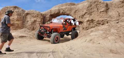 1992 Jeep Wrangler - Off-roading in a 1992 Jeep Wrangler through a desert archway.