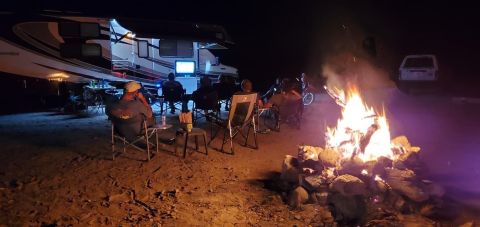 1992 Jeep Wrangler - Campfire gathering at night with an RV and a television set up outdoors.
