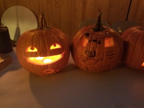 1990 Ford Bronco - Carved pumpkins sit on a table, lit from inside, with one a simple carved face and the other a drawn face.