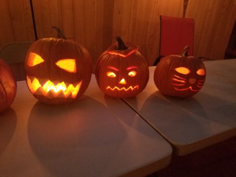 1990 Ford Bronco - Carved pumpkins with Halloween faces sit on a table, illuminated from within.