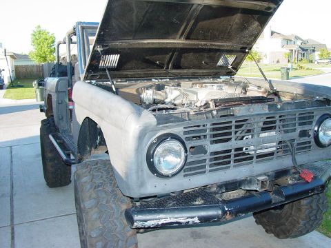 1972 Ford Bronco - This Ford Bronco has its hood open, revealing the engine compartment and large off-road tires.