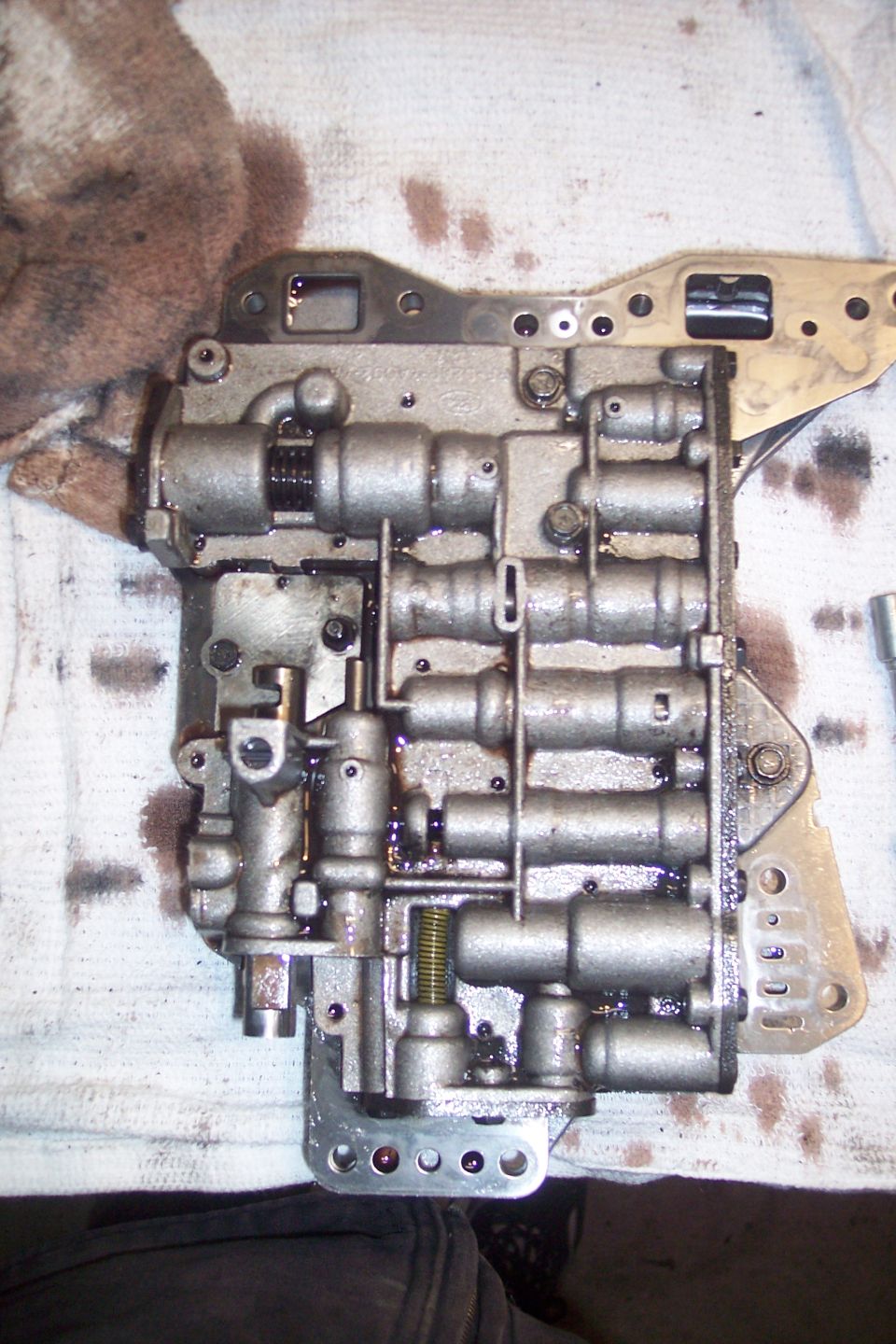 Transmission valve body covered in oil.