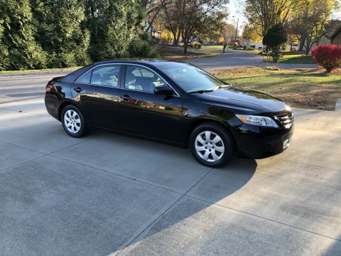 2011 Toyota Camry - A black sedan is captured from a 3/4 front angle on a paved surface.