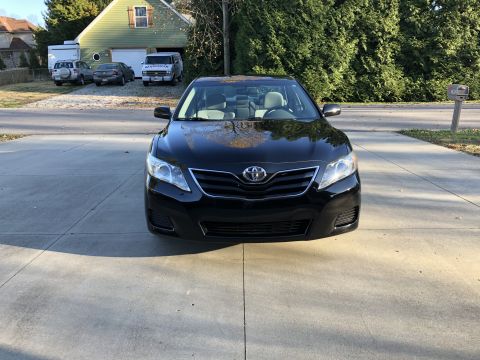 2011 Toyota Camry - A black sedan is parked on a street with another vehicle visible in the background.