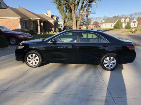 2011 Toyota Camry - Side profile of a black 2011 Toyota Camry on a sunny day.
