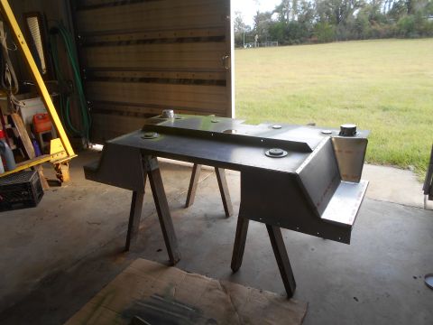 1992 Ford Bronco - A custom-built metal tank assembly, possibly for a vehicle, is shown resting on sawhorses in a garage or workshop. The assembly has multipl…