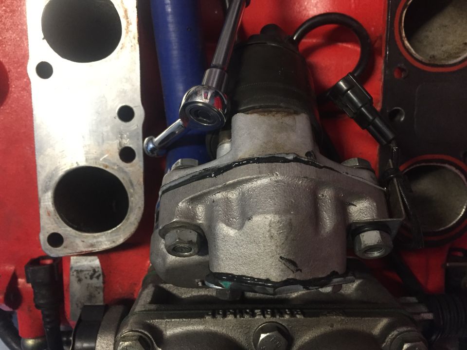 Engine component with blue hose and silver bracket