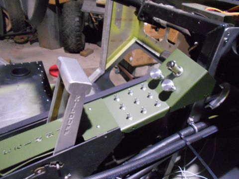 1992 Ford Bronco - A close-up view of a custom aircraft-style control panel with multiple toggle switches and knobs, featuring a large silver lever with engra…