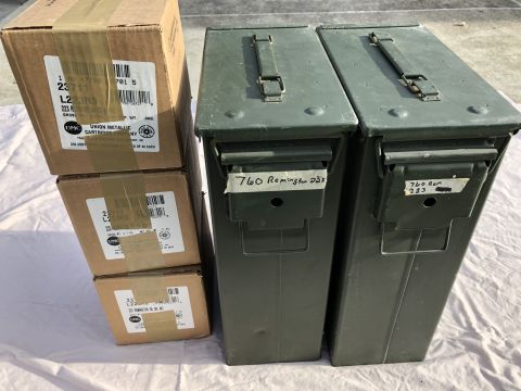 1995 Mercury Grand Marquis - Cardboard boxes of UMC 223 Remington cartridges are stacked beside two green ammo cans.