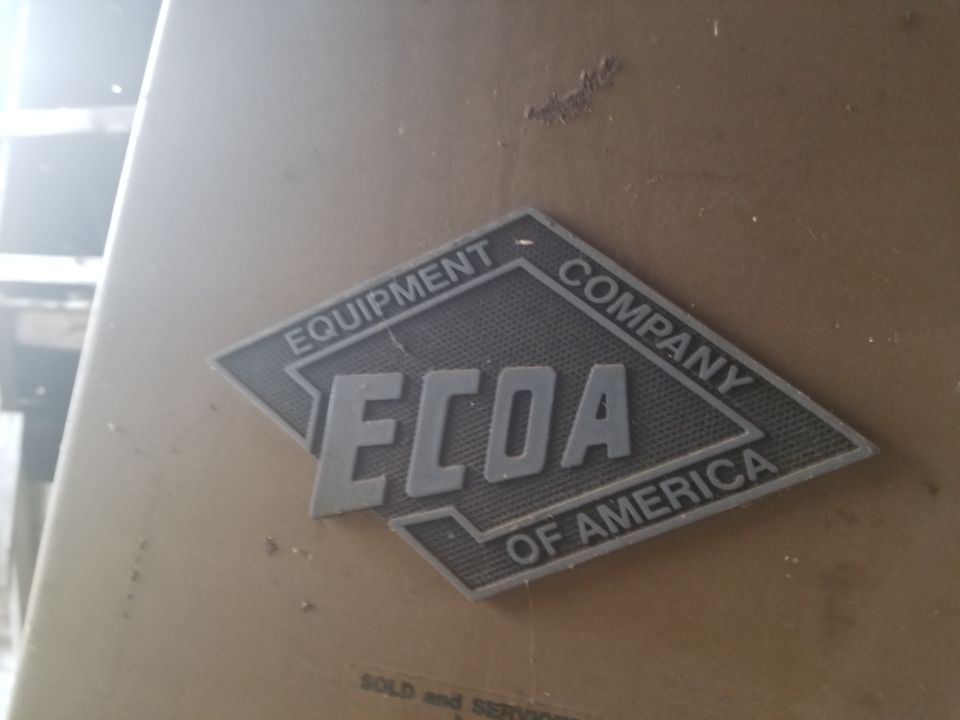 ECOA Equipment Company of America badge on a tan surface